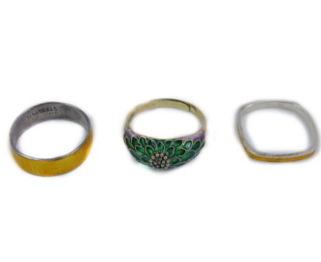 Three silver and enamel rings, comprising a silver gilt and green and purple enamel floral dress ring, a silver and yellow en