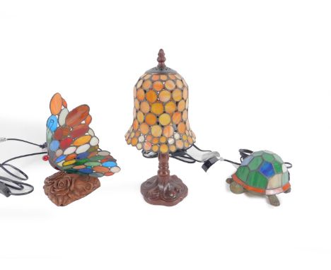 *Three Tiffany style table lamps, comprising a butterfly, 22cm H; a tortoise, 20cm L; and a table lamp with a mushroom shaped