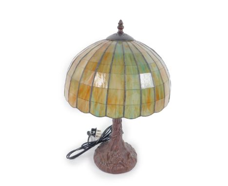 *A Tiffany style table lamp with a mottle blue and brown shade, on a faux metal tree trunk base, 47cm H, 32cm Dia. (boxed)