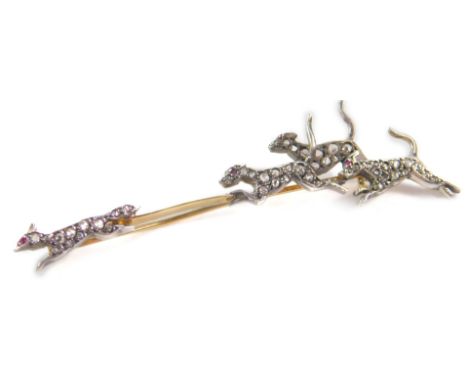 A diamond fox and triple hound brooch, set with old cut diamonds and ruby set eyes, in yellow metal, one diamond lacking, 4.0