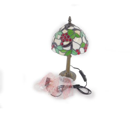 *A Tiffany style table lamp decorated in the grapes pattern,  raised on a faux metal stemmed base, 37cm H, 18.5cm Dia. (boxed