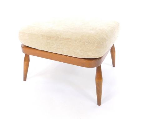 An Ercol oak stool, with a fawn overstuffed cushion seat, raised on turned legs, 54cm dia.