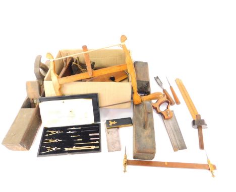 Victorian and later tools, including a coping saw, moulding planes, ebony and brass square, together with a set of drawing in
