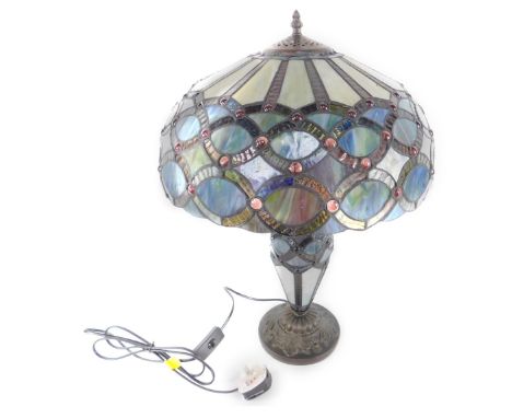 *A Minster Tiffany style table lamp, with a circular jeweled glass shade and stem, raised on a faux metal base,  50cm H, 40cm