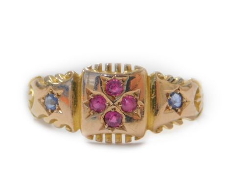 A 15ct gold gypsy ring set with a central four leaf design, each set with tiny ruby, flanked by star design shoulders, each s