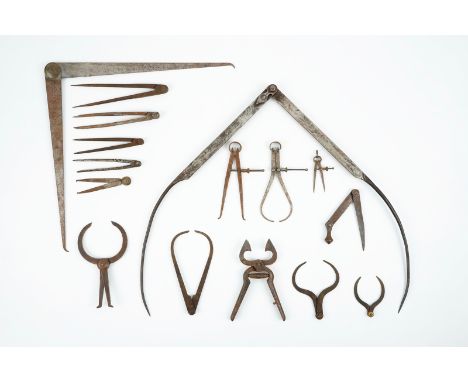 A set of wrought iron compasses and measuring tools, 18/19th C. Various dimensions. Condition reports and high resolution pic