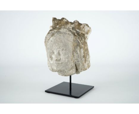 A carved stone head of a female saint, 14/15th C. H.: 30 cm (incl. stand) 