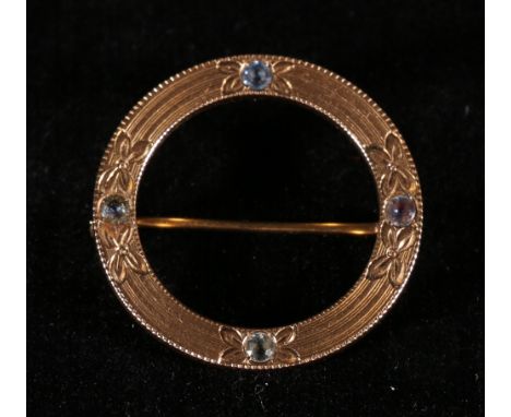 14ct gold sapphire brooch of circular form with engraved flower head decoration