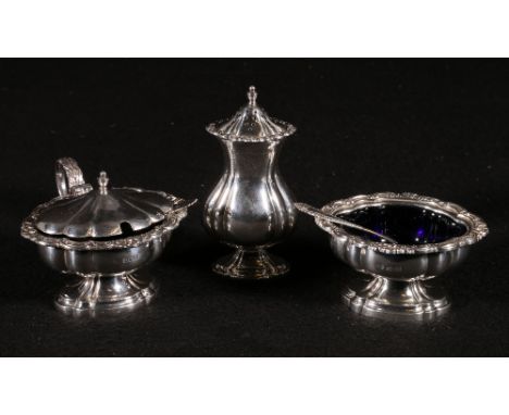 Silver four piece condiment set of scroll outline raised on a socle base