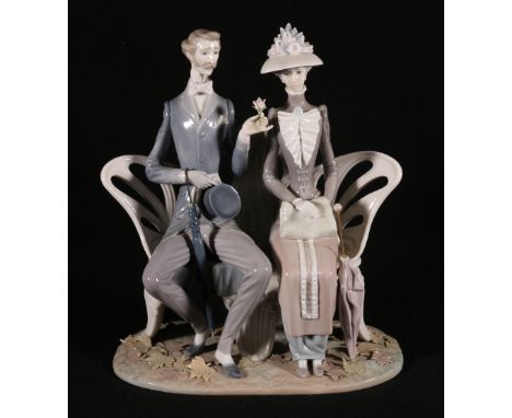 Lladro figure group modelled as a couple upon a bench in Autumnal setting, 30cm tall. CONDITION REPORT: No issues with comdit