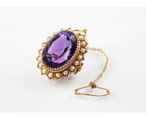 A continental amethyst and pearl 14ct gold cluster brooch, the central oval mixed cut amethyst measuring 22mm x 16.5mm, claw 