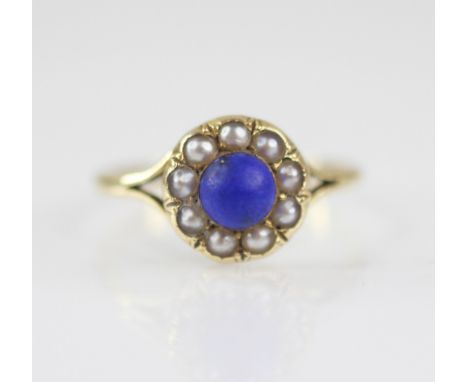 An early 20th century lapis lazuli and pearl floral cluster ring, the central lapis lazuli measuring 5.2mm diameter, with a s