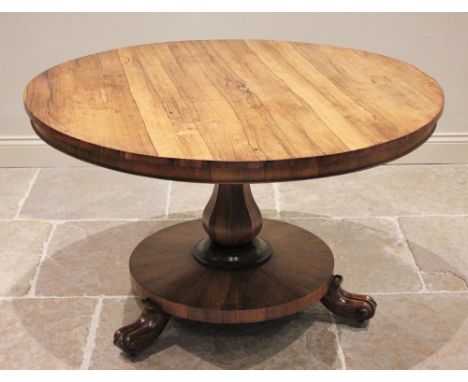 A mid 19th century rosewood pedestal breakfast table, the circular tilt top raised upon an octagonal baluster column extendin