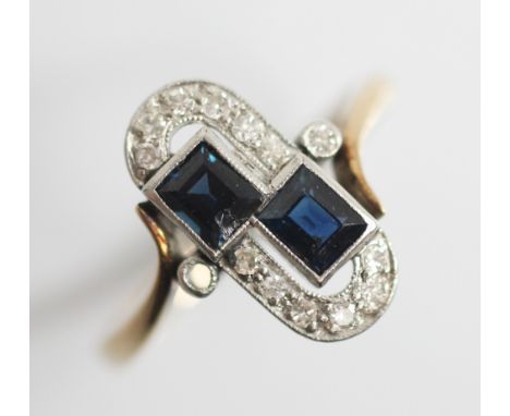 An Art Deco sapphire and diamond 9ct gold and platinum ring, comprising two rectangular step cut sapphires set to a diamond s