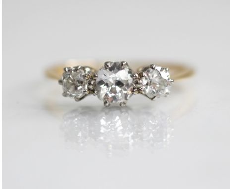 An early 20th century diamond three-stone ring, the central old cushion cut diamond measuring 5.51mm x 4.62mm x 2.99mm, with 