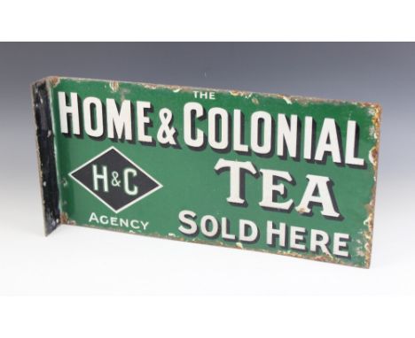 A vintage double sided enamel advertising sign for "HOME &amp; COLONIAL TEA", the text in white drop shadowed font against a 