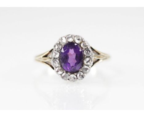 A Victorian amethyst and diamond cluster ring, the central oval mixed cut amethyst measuring 7.18mm x 5.49mm, with a surround