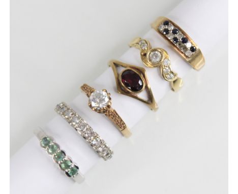 A selection of 9ct gold dress rings, to include; a garnet set 9ct gold dress ring, size N 1/2, a paste set 9ct white gold ete