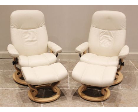 A pair of Ekornes 'Stressless' reclining armchairs, in cream leather, with conforming footstools, late 20th/early 21st centur