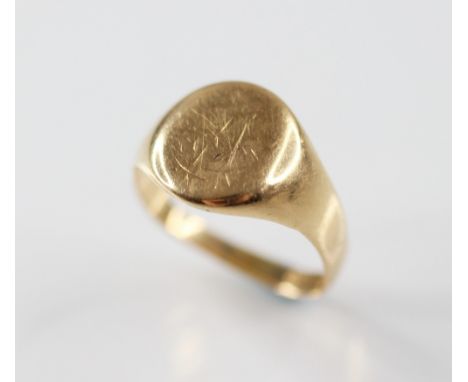 An Edwardian 18ct gold signet ring, the oval head with engraved monogramed initials (worn), continuing to a plain polished ta