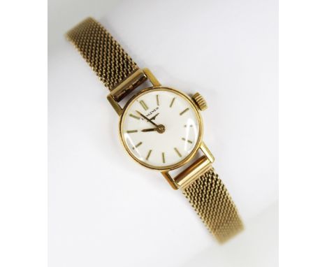 A ladies vintage 18ct gold Longines wristwatch, the circular white dial with baton markers, plain polished 18ct gold case, ma
