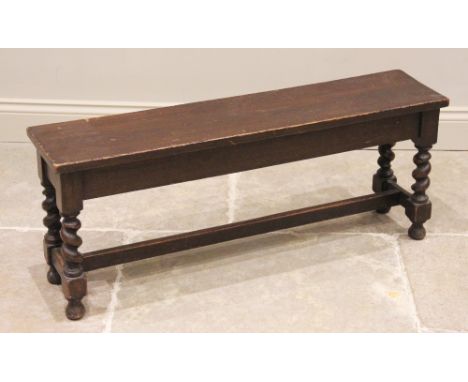 An early 20th century oak hall bench/window seat, the rectangular board seat raised upon barley twist and block supports unit