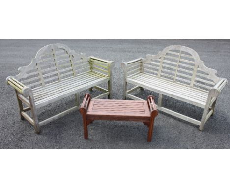 A pair of Lutyens type benches, each with an arched back extending to scrolled arms, raised upon legs of square section, 165c