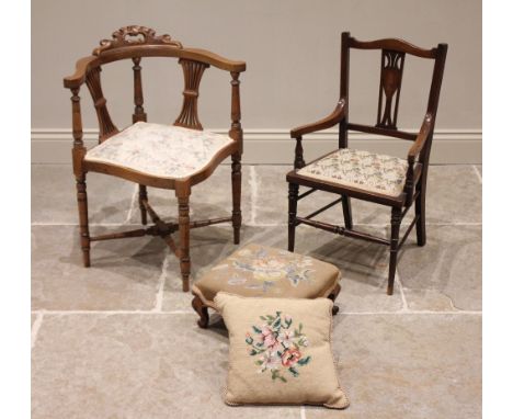 A late Victorian walnut corner chair, with twin pierced splats above an upholstered seat, raised upon annulated legs united b