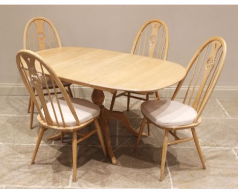 An Ercol light elm and beech 'Chester' pedestal extending dining table with four Ercol chairs, late 20th century, the oval ta