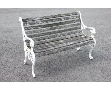A 19th century style painted metal and slatted hardwood bench, the supports cast with lion mask terminals upon scrolled feet,