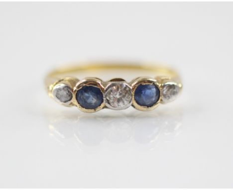 An early 20th century sapphire and diamond five-stone ring, the central round old cut diamond weighing approximately 0.10 - 0