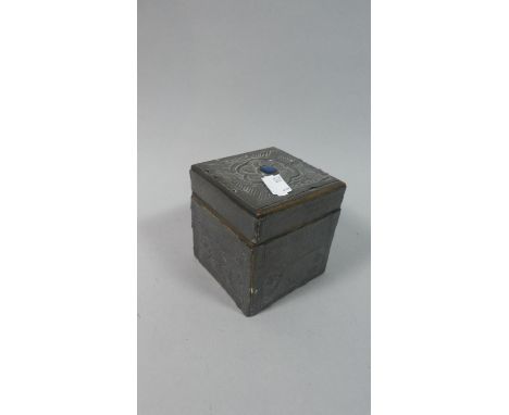 A Tin Mounted Wooden Tea Caddy with Embossed Decoration and Blue Cabochon to Lid, 8.75cm Square 