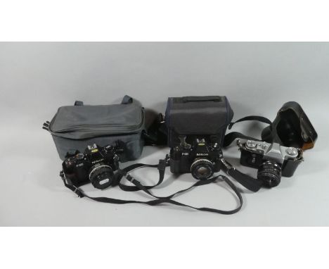 A Vintage Russian Zenit 35mm Camera Together with Two Nikon F-301 35mm Cameras 