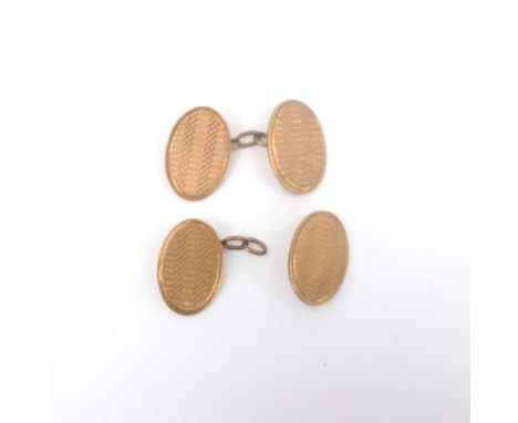 A pair of vintage 9ct gold oval cufflinks with engine turned decoration, united by chain links (af), combined approx. 10.7g.C