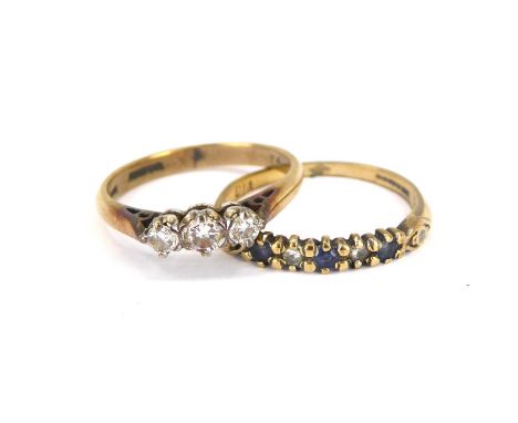 A 9ct gold ring with three small claw set graduated diamonds and a 9ct gold half eternity diamond and sapphire ring, both siz