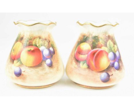 ROYAL WORCESTER; two small porcelain vases, both hand painted with a similar 'Fallen Fruit' design and with gilt edging, shap