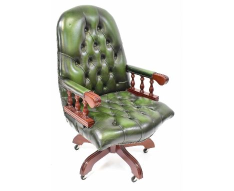 A modern reproduction swivel office chair with green leather button back and seat.Condition Report: Overall good but used con