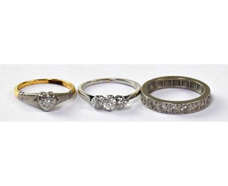 A white metal ring claw set with three diamonds, size L, approx. 2.3g, together with an 18ct yellow gold ring with white gold