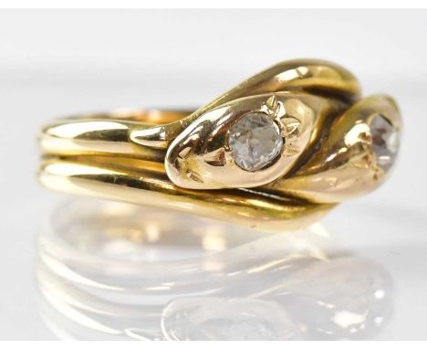 An 18ct yellow gold double snake ring, each head set with a 0.2ct diamond, size R, approx. 8g.