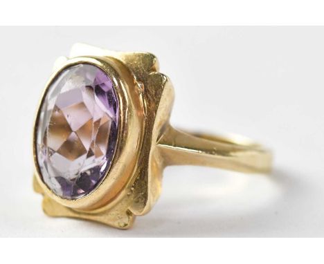 Four dress rings comprising a 9ct gold ring set with amethyst, stamped 375, size M1/2, approx. 4.6g, an 18ct gold ring set wi