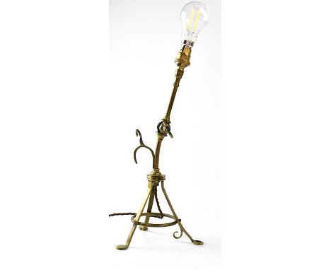 An unusual brass articulated reading lamp with tripod base doubling as a wall mounting hook, height 40cm.Condition Report: - 