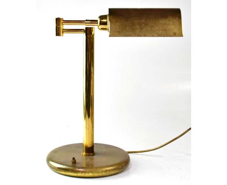 A brass reading lamp with adjustable brass shade, on two swinging arms to circular base, height 43cm.Condition Report: - This