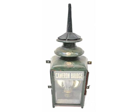 A late 19th/early 20th century wall-mounted three-glass oil lamp, with applied brass plaques to the upper tiers, the top one 