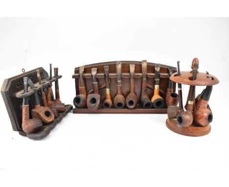 Three pipe racks and seventeen various pipes.Condition Report: These pipes have all been smoked and are in various used condi