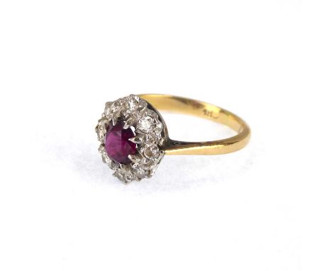 An 18ct gold ring set with central claw set ruby within a border of tiny diamonds, size N, approx. 3.3g.Condition Report: Min