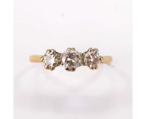 An 18ct gold ring with three claw set brilliant cut diamonds, approx. 0.3ct flanked by 0.2ct, size Q, approx. 1.8g.