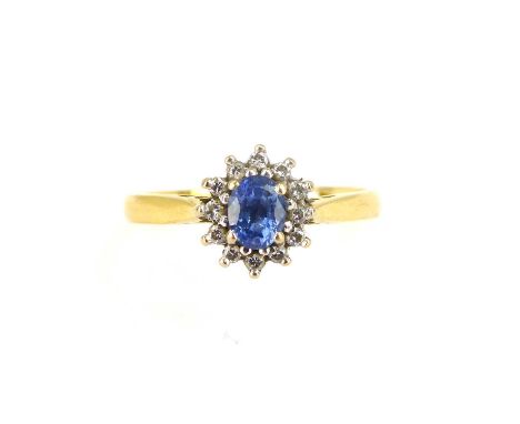 An 18ct gold ring with central claw set sapphire surrounded by tiny diamonds, size P, approx. 3.5g.Condition Report: Chips to