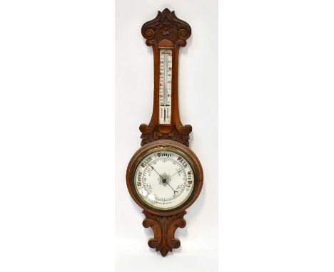 An early 20th century carved oak banjo aneroid barometer with enamelled dial and thermometer, height 85cm.Condition Report: -