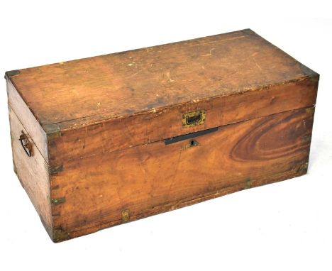 A wooden trunk, possibly elm or ash, with brass fittings, carry handles and candle box to interior, 34 x 80.5 x 38cm.