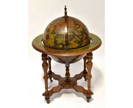 A reproduction drinks cabinet in the form of a terrestrial globe, with hinged lid enclosing a set of five tumblers, two metal